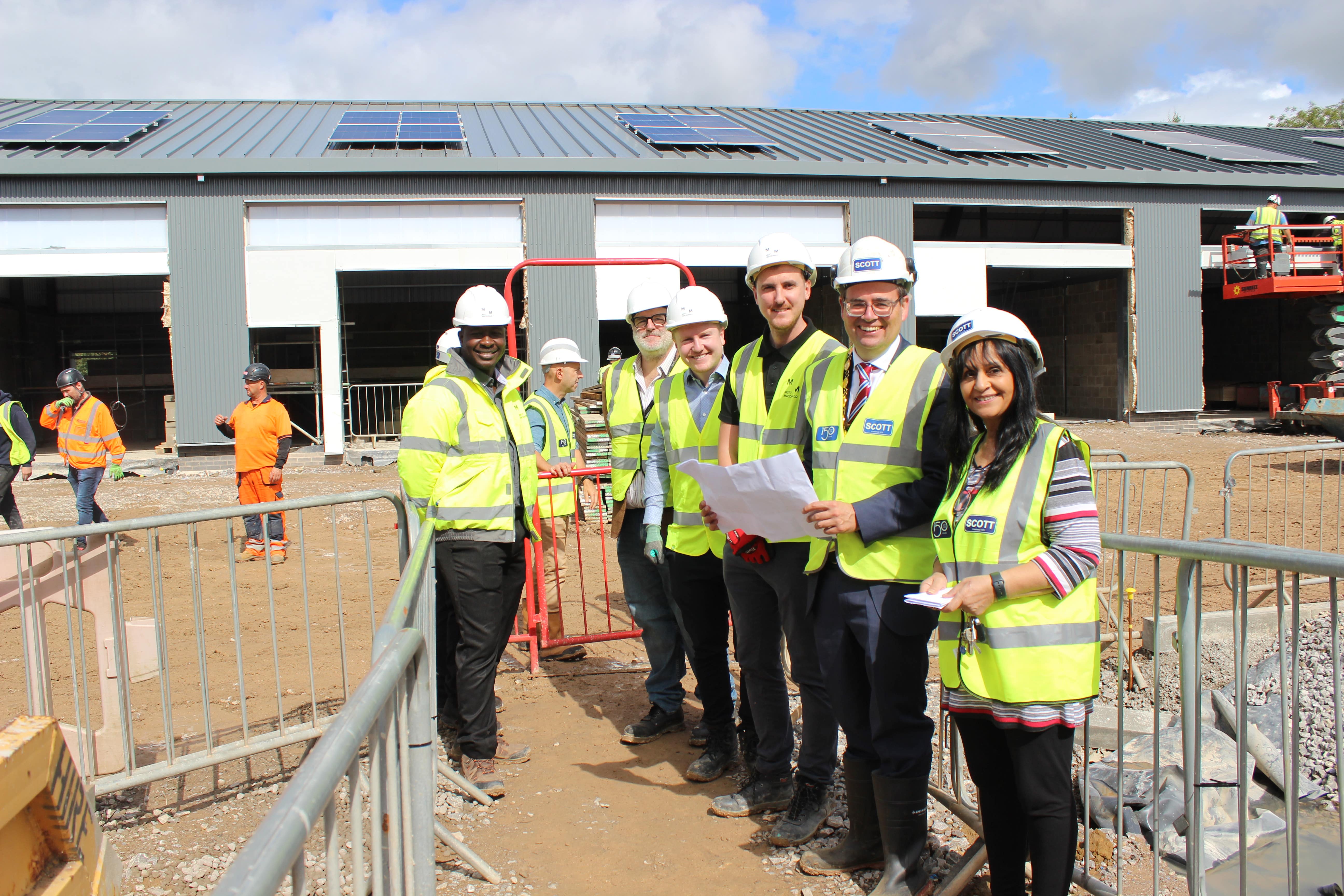 (L – R) Robert Frowen, Economic Development Team Manager at Bridgend County Borough Council, Councillor Huw David, Mayor of Bridgend County Borough and Councillor Neelo Farr, Cabinet Member for Regeneration with members of the Andrew Scott Ltd team at the site works at Village Farm Industrial Estate, Pyle.